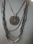 collana con perline nere, tessuto tubolare nero e filo lurex, catena metallica nero/argento e pendente in bachelite nera 12 euro